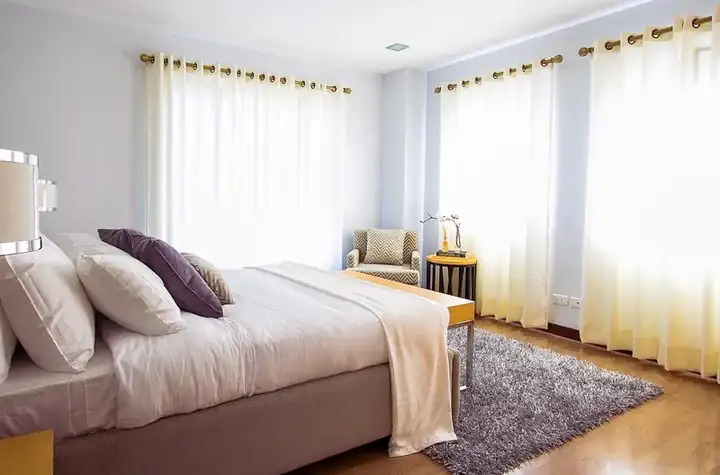 Coastal bed with a whitewashed slatted headboard and light driftwood-tone frame, handcrafted in Jodhpur, India